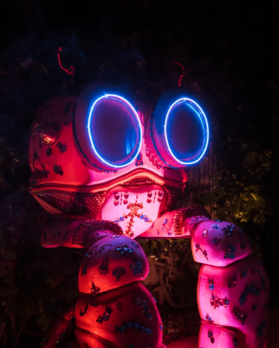Neon art installation glowing against the night at Island