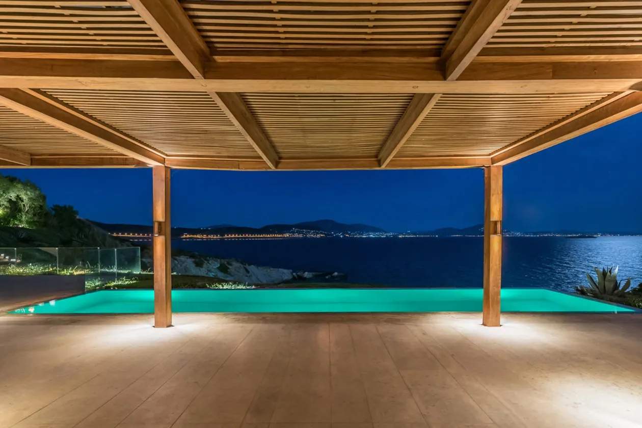 Private House covered terrace facing the sea at night