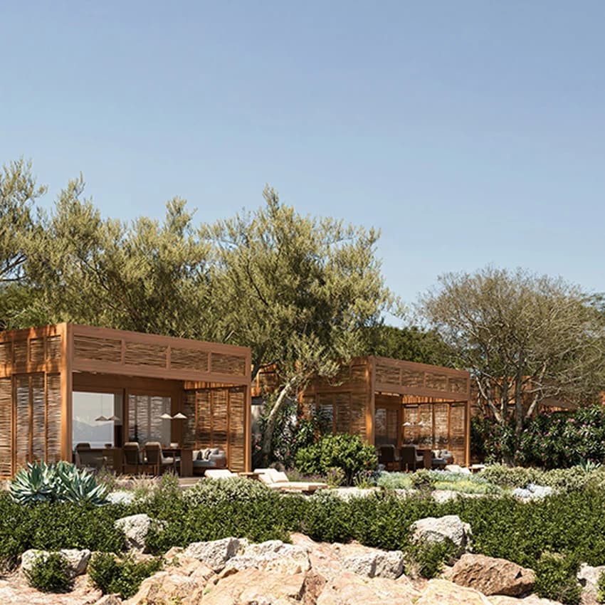 Wooden cabanas among trees and rocks at The Cabanas